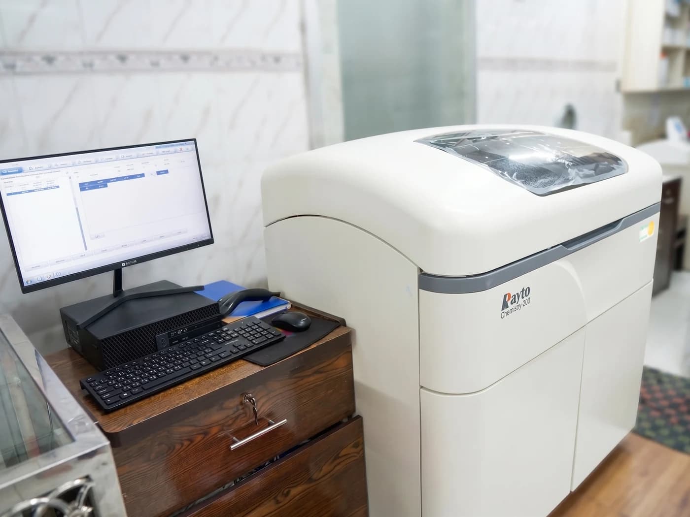 A Rayto Chemistry-200 automated biochemistry analyser and its workstation in the Dhaka Clinic laboratory, Tangail