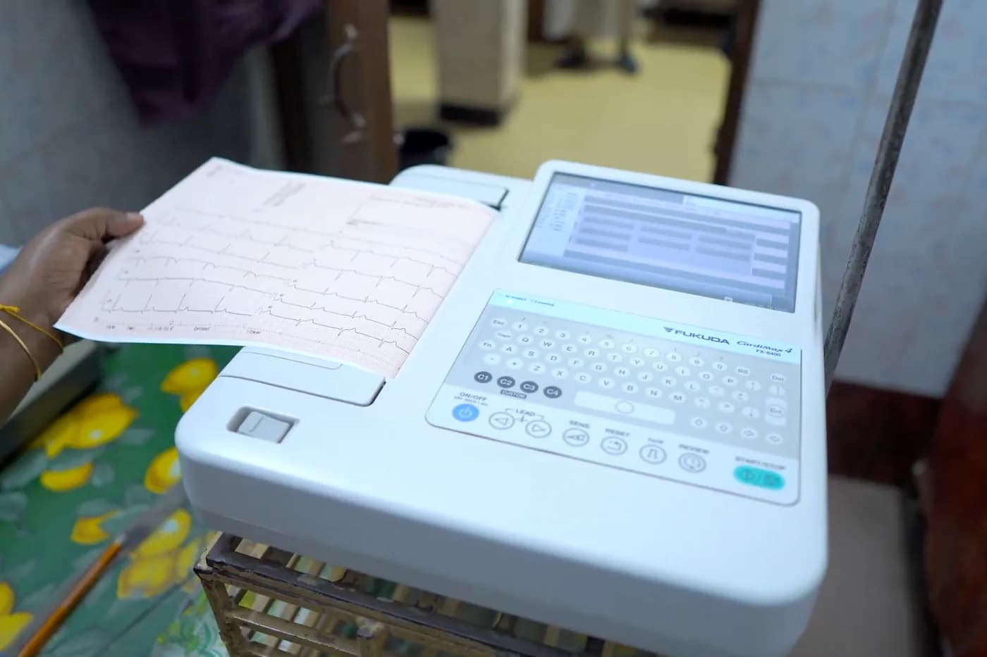 Twelve-lead ECG machine printing a trace at Dhaka Clinic, Tangail