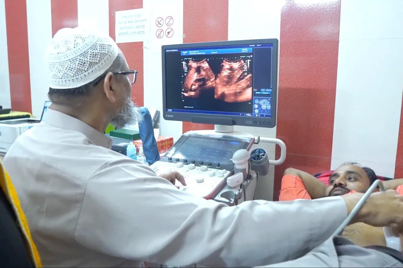 Consultant scanning a patient with the colour Doppler ultrasound machine at Dhaka Clinic, Tangail