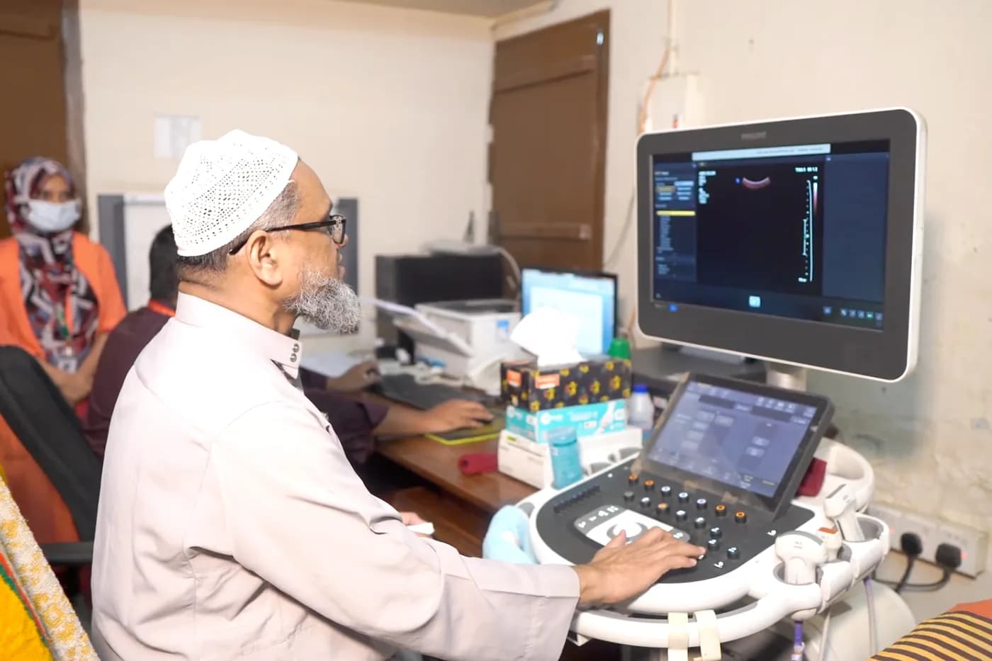 Consultant performing an ultrasound scan at Dhaka Clinic, Tangail
